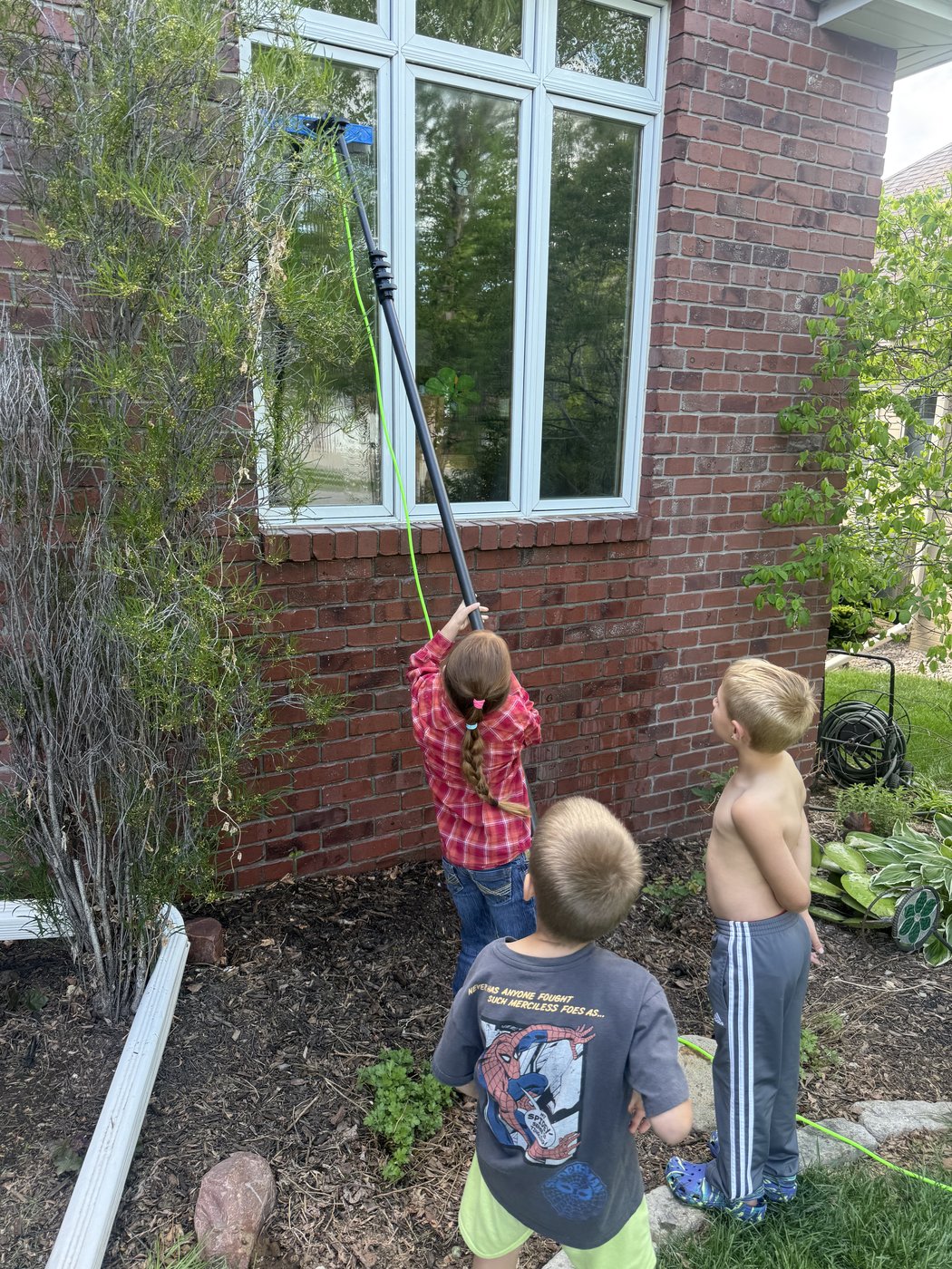 Water-fed pole window cleaning system in action in Lincoln